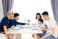 Happy Asian extended family having dinner at home full of laughter and happiness Royalty Free Stock Photo