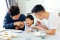 Happy Asian extended family having dinner at home full of laughter and happiness. Royalty Free Stock Photo