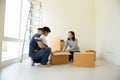 Asian family with cardboard boxes in new house at moving day. Royalty Free Stock Photo