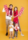 Happy asian family celebrating chinese new year. chinese text : congratulation and get rich