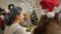 Happy asian family celebrating Christmas together at home. Cheerful senior parents and children in Santa hat Royalty Free Stock Photo