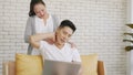 Family couple husband and wife laughing sitting on sofa using laptop computer working from home Royalty Free Stock Photo