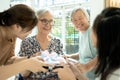 Happy asian family,daughter, granddaughter visiting and giving gift to old grandparent,excited female elderly hold present box,