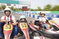 Happy family driving go kart on the track Royalty Free Stock Photo