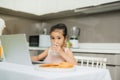 Happy Asian family are eating breakfast and see digital tablet in the kitchen at home. Healthy food and Morning activities Royalty Free Stock Photo