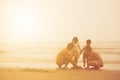 Happy Asian family enjoy together playing fun on the beach summer vacation sunset light in Thailand sea Royalty Free Stock Photo