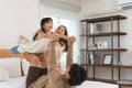 Happy Asian family, father, mother, cute daughter playing on bed in bedroom at home, bond and relax together. Little girl having Royalty Free Stock Photo