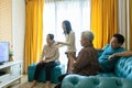 Happy asian family,father,mother,daughter,and senior grandmother relaxing,watching movies dramas series on TV,enjoying watch Royalty Free Stock Photo