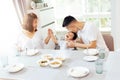 Happy Asian family of father, mother and son playing and laughing while having dinner Royalty Free Stock Photo