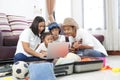 Happy asian family on a floor at home planning vacation travel t Royalty Free Stock Photo