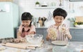 Happy asian family funny kids are preparing the dough, bake cookies in the kitchen Royalty Free Stock Photo