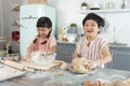 Happy asian family funny kids are preparing the dough, bake cookies in the kitchen Royalty Free Stock Photo