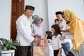 family giving present to their muslim grandparents during eid mubarak celebration Royalty Free Stock Photo