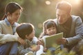 Happy asian family having a good time outdoors in city park Royalty Free Stock Photo