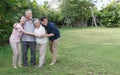 happy asian family hugging together with adult son young daughter senior father and old mother in garden park back yard at home. Royalty Free Stock Photo