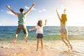 Happy family jumping on the beach Royalty Free Stock Photo