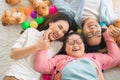 Happy Asian family laying on carpet in living room and smile with their daughter down syndrome child   a lot color balls and teddy Royalty Free Stock Photo