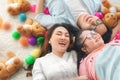 Happy Asian family laying on carpet in living room and smile with their daughter down syndrome child , a lot color balls and teddy Royalty Free Stock Photo
