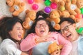 Happy Asian family laying on carpet in living room and smile with their daughter down syndrome child , a lot color balls and teddy Royalty Free Stock Photo