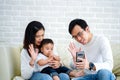 Happy Asian family making a video call at home Royalty Free Stock Photo