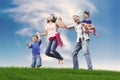 Happy Asian Family in Meadow Royalty Free Stock Photo