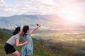Happy asian family mother and daughter taking selfie on the top of mountain Royalty Free Stock Photo