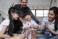 Happy Asian family, parents, and kids are playing with wooden blocks together Royalty Free Stock Photo