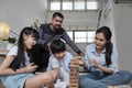 Happy Asian family, parents, and kids are playing with wooden blocks together Royalty Free Stock Photo