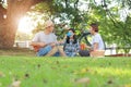 Happy asian family picnic in the park togetherness Royalty Free Stock Photo