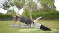 Happy asian family playing with children doing yoga exercises on grass in the park at the day time Royalty Free Stock Photo