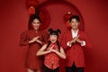 Happy asian family in red casual attire with gesture of congratulation greeting happy chinese new year 2024 Royalty Free Stock Photo