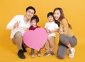 Happy asian family showing the heart and love shape sign