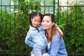 Happy asian family single mom and small daughter in the Park