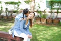 Happy asian family single mom and small daughter in the Park