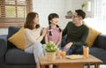 Happy Asian family sitting together on sofa at home living room Royalty Free Stock Photo