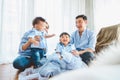 Happy Asian family smile and laugh together in bedroom at home. Two parents and children. People lifestyle in state quarantine Royalty Free Stock Photo