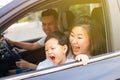 Happy Asian family is smiling and travelling on the road trip, going for a drive for vacation. Royalty Free Stock Photo