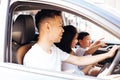 Happy Asian family is smiling and travelling on the road trip, going for a drive for vacation. Royalty Free Stock Photo