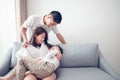 Happy Asian family with son at home on the sofa playing and laughing Royalty Free Stock Photo