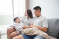 Happy Asian family with son at home on the sofa playing and laughing Royalty Free Stock Photo