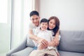 Happy Asian family with son at home on the sofa playing and laughing Royalty Free Stock Photo