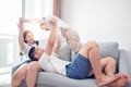 Happy Asian family with son at home on the sofa playing and laughing Royalty Free Stock Photo