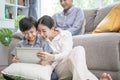 Happy asian family spending time together on sofa in living room. family and home concept. Royalty Free Stock Photo