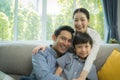 Happy asian family spending time together on sofa in living room. family and home concept. Royalty Free Stock Photo