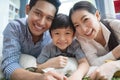 Happy asian family spending time together on sofa in living room. family and home concept. Royalty Free Stock Photo