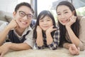 Happy asian family spending time together on sofa in living room. family and home concept. Royalty Free Stock Photo