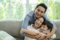 Happy asian family spending time together on sofa in living room. family and home concept. Royalty Free Stock Photo