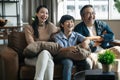 Happy Asian family spending time by watching tv together on sofa in living room. family and home concept. Royalty Free Stock Photo