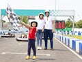 Happy family standing on the go kart race track Royalty Free Stock Photo