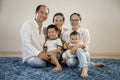 Happy asian family together white background sitting on floor Royalty Free Stock Photo